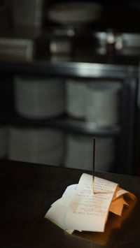Multiple receipts stacked on a ticket spike