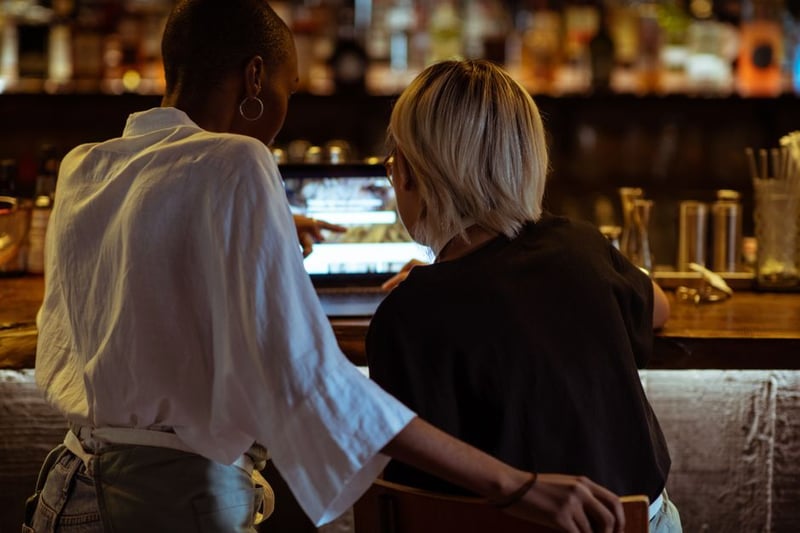 Two people looking at a laptop together