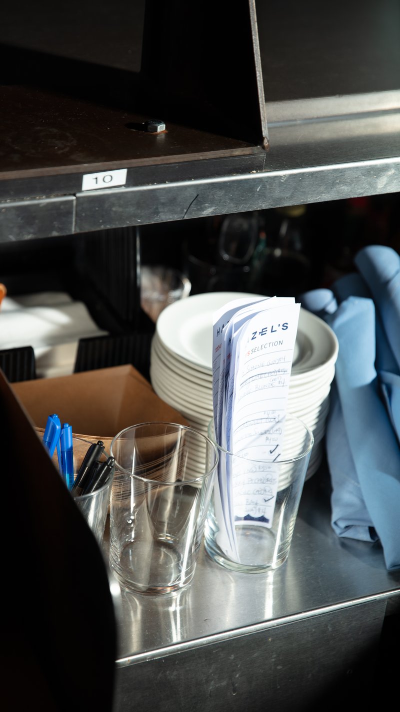 Glasses, plates, and order slips on counter
