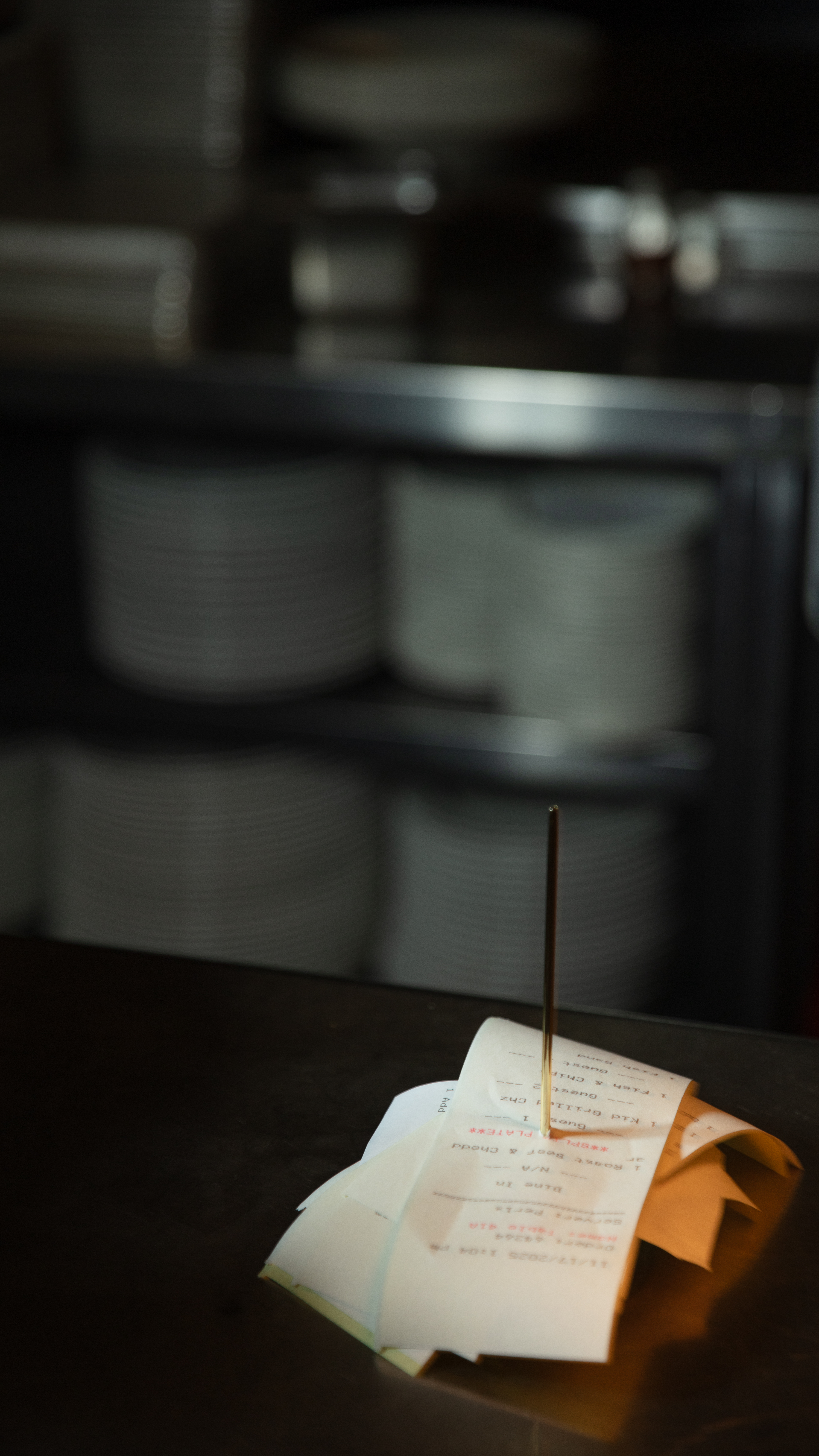 Multiple receipts stacked on a ticket spike